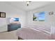 Cozy bedroom with large TV, neutral carpet, and a window with a view at 3280 Canna Lily Pl, Clermont, FL 34711