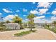 An inviting entrance to the Waterbrooke community, featuring lush landscaping, palm trees, and brick-paved roads at 3280 Canna Lily Pl, Clermont, FL 34711