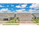 Charming single Gathering home with a two-car garage, well-maintained landscaping, and beautiful curb appeal at 3280 Canna Lily Pl, Clermont, FL 34711