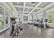 A modern fitness center featuring state-of-the-art exercise equipment, ample natural light, and ceiling fans at 3280 Canna Lily Pl, Clermont, FL 34711