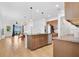 Bright open kitchen featuring stainless steel appliances, large island, and dining area with backyard view at 3280 Canna Lily Pl, Clermont, FL 34711
