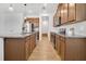 Well-lit kitchen featuring granite countertops, stainless steel appliances, and wood cabinets at 3280 Canna Lily Pl, Clermont, FL 34711