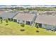Aerial view of home's rear exterior showing a large lot with lush lawn and screened lanai at 3280 Canna Lily Pl, Clermont, FL 34711