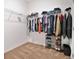 Well-organized walk-in closet with shelves, hanging rods, and a shoe rack at 3280 Canna Lily Pl, Clermont, FL 34711
