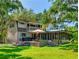 Expansive backyard featuring a deck, patio, and screened porch for outdoor living at 3443 S Mellonville Ave, Sanford, FL 32773