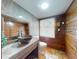 Unique bathroom with wood walls, stone countertop sink, and tiled floors at 3443 S Mellonville Ave, Sanford, FL 32773