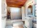 Well-lit bathroom featuring a shower, tiled floor and walls, vintage mirror, and stylish vanity at 3443 S Mellonville Ave, Sanford, FL 32773