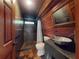 Modern bathroom with stone shower, a sleek vanity, and wood-paneled walls at 3443 S Mellonville Ave, Sanford, FL 32773