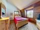 Cozy bedroom with natural light, wood accents, and a comfortable bed and dresser at 3443 S Mellonville Ave, Sanford, FL 32773
