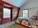 Bright bedroom with wood accents, two windows, and carpet floors at 3443 S Mellonville Ave, Sanford, FL 32773
