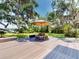 Outdoor deck area featuring an umbrella-covered picnic table and lovely waterfront views at 3443 S Mellonville Ave, Sanford, FL 32773