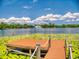 View of the dock on the lake with gorgeous skies above, ideal for fishing or watching sunsets at 3443 S Mellonville Ave, Sanford, FL 32773