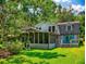 Back exterior view showing a screened lanai and the attractive architecture of this charming two-story home at 3443 S Mellonville Ave, Sanford, FL 32773