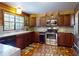 Traditional kitchen with stainless steel appliances, granite countertops, and custom cabinetry at 3443 S Mellonville Ave, Sanford, FL 32773