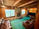 Inviting living room showcasing a stone fireplace, natural wood walls, and comfortable seating, perfect for relaxation at 3443 S Mellonville Ave, Sanford, FL 32773