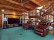 Cozy living room featuring a striking wooden staircase and comfortable leather seating with entertainment options at 3443 S Mellonville Ave, Sanford, FL 32773