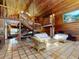 Expansive living area showcasing wood-paneled walls, high ceilings, and a charming staircase to the upper level at 3443 S Mellonville Ave, Sanford, FL 32773