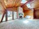 Sunlit living room with wood paneling, a brick fireplace, vaulted ceilings, skylights, and a white love seat at 3443 S Mellonville Ave, Sanford, FL 32773