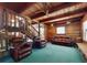 Spacious living room with wood-paneled walls, a ceiling fan, plush seating, and an open staircase at 3443 S Mellonville Ave, Sanford, FL 32773