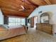 Bright main bedroom with a wood-paneled ceiling, an ornate dresser, and a sliding glass door to the balcony at 3443 S Mellonville Ave, Sanford, FL 32773
