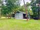 Outbuilding with covered parking, offering space for cars and equipment, set on the home's ample lot at 3443 S Mellonville Ave, Sanford, FL 32773
