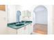 Bright bathroom featuring double sinks with green marble countertop, white cabinets, and arched doorway at 4236 Newtonhall Dr, Orlando, FL 32826