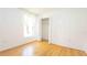 Bright bedroom with wood floors, large window, and closet at 4236 Newtonhall Dr, Orlando, FL 32826