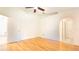 Spacious bedroom featuring wood floors, ceiling fan, and arched doorway leading to the bathroom at 4236 Newtonhall Dr, Orlando, FL 32826