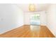 Sunny dining room with hardwood floors and sliding glass doors to backyard at 4236 Newtonhall Dr, Orlando, FL 32826