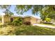Single-Gathering home featuring a well-maintained lawn, landscaping, and a two-car garage at 4236 Newtonhall Dr, Orlando, FL 32826