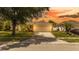Exterior view of a single Gathering home featuring a front lawn, and a two car garage at 4236 Newtonhall Dr, Orlando, FL 32826