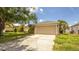 Single-Gathering home showcasing a well-maintained lawn, palm trees, and a two car garage at 4236 Newtonhall Dr, Orlando, FL 32826
