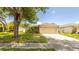 Charming single-story home with a two-car garage and a lush front lawn at 4236 Newtonhall Dr, Orlando, FL 32826