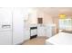 Bright kitchen with white appliances and cabinets, adjacent to dining area at 4236 Newtonhall Dr, Orlando, FL 32826