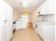 Eat in kitchen featuring white cabinets and a view into the dining area at 4236 Newtonhall Dr, Orlando, FL 32826