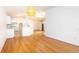 Open-concept living space with hardwood floors and modern lighting fixtures at 4236 Newtonhall Dr, Orlando, FL 32826