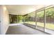Enclosed back porch with a concrete floor and view to the fenced backyard at 4236 Newtonhall Dr, Orlando, FL 32826