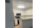 Modern kitchen featuring white cabinets, stainless steel appliances, and stone countertops at 460 Sand Lime Rd, Winter Garden, FL 34787