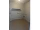 Utility Room featuring painted floors, hookups, and storage at 460 Sand Lime Rd, Winter Garden, FL 34787
