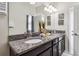 Bathroom featuring dual sinks with granite countertops and modern fixtures at 4740 Sleepy Hollow Dr, Kissimmee, FL 34746