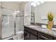 This bathroom has a tiled shower, dark brown cabinets with granite countertops, and a plant as a decoration at 4740 Sleepy Hollow Dr, Kissimmee, FL 34746