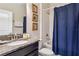 A clean bathroom with granite countertops, single sink, a shower-tub combo, and 3 wall decorations at 4740 Sleepy Hollow Dr, Kissimmee, FL 34746