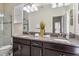 Bright bathroom boasts double sinks with granite countertops and a separate glass-enclosed shower at 4740 Sleepy Hollow Dr, Kissimmee, FL 34746