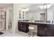 Bathroom featuring double sinks, granite countertop, tiled floors, and glass shower at 4740 Sleepy Hollow Dr, Kissimmee, FL 34746