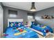 Cozy bedroom with two twin beds, gray walls, and Mickey Mouse themed bedding at 4740 Sleepy Hollow Dr, Kissimmee, FL 34746