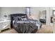Comfortable bedroom features a luxurious upholstered bed with a mirrored full-length and a well-lit nightstand at 4740 Sleepy Hollow Dr, Kissimmee, FL 34746