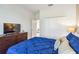 Bedroom features a dark wood dresser with a television, closet, and an upholstered headboard bed at 4740 Sleepy Hollow Dr, Kissimmee, FL 34746