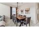 Stunning dining room with wood table, gray upholstered chairs, modern lighting and artwork at 4740 Sleepy Hollow Dr, Kissimmee, FL 34746