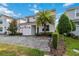 Two-story home featuring a brick driveway, palm tree, manicured bushes, and a one-car garage at 4740 Sleepy Hollow Dr, Kissimmee, FL 34746