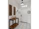 Entrance hallway featuring modern decor, marble tile floors, and a white front door at 4740 Sleepy Hollow Dr, Kissimmee, FL 34746